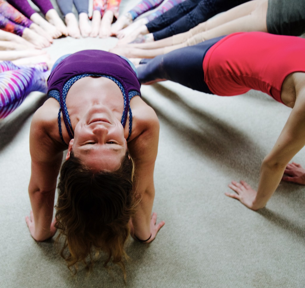 Close up of Yoga student in a circle of reverse plank poses