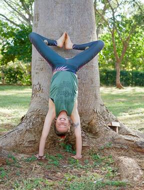 Soma Yoga Student practices yoga outdoors and enjoys the health enhancing benefits