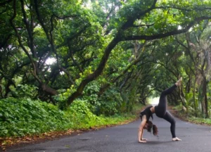 Wheel Pose with Lifted leg at yoga teacher training program in Hawaii