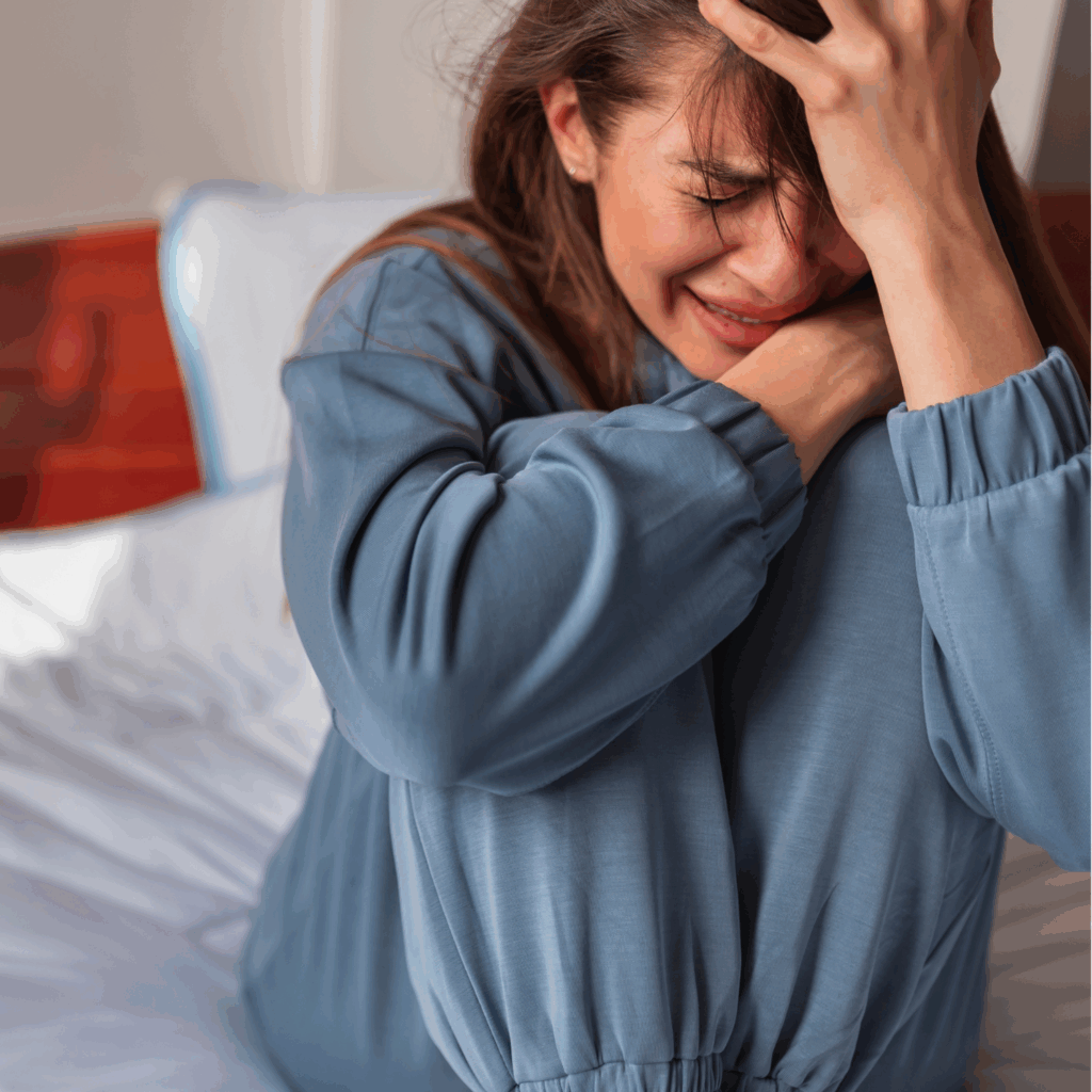 Young girl crying and holding her head, illustrating emotional stress and anxiety in children.